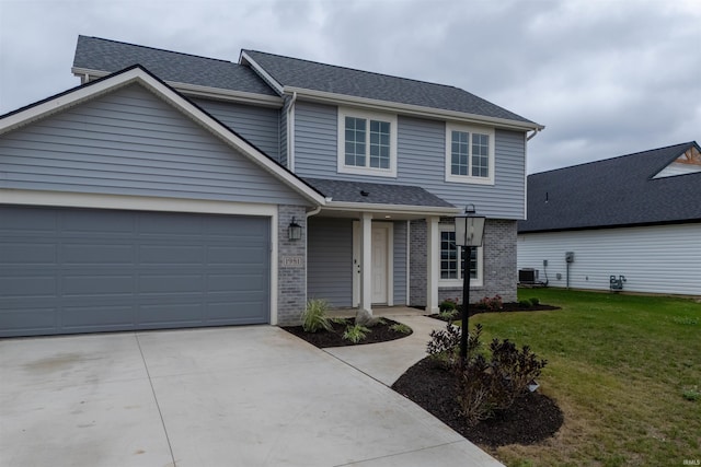 front facade with central air condition unit, a front yard, and a garage