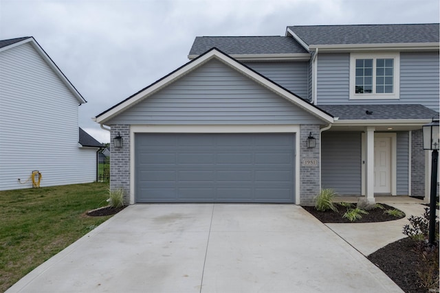 view of front of property with a front yard and a garage