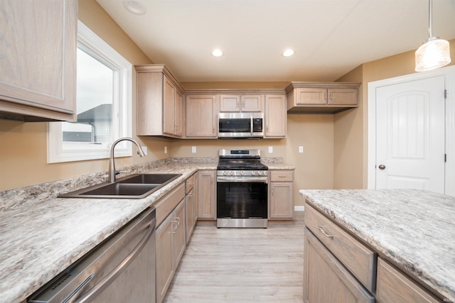 kitchen featuring light brown cabinetry, sink, appliances with stainless steel finishes, and light wood-type flooring