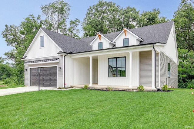 modern farmhouse featuring a front yard, a garage, and covered porch