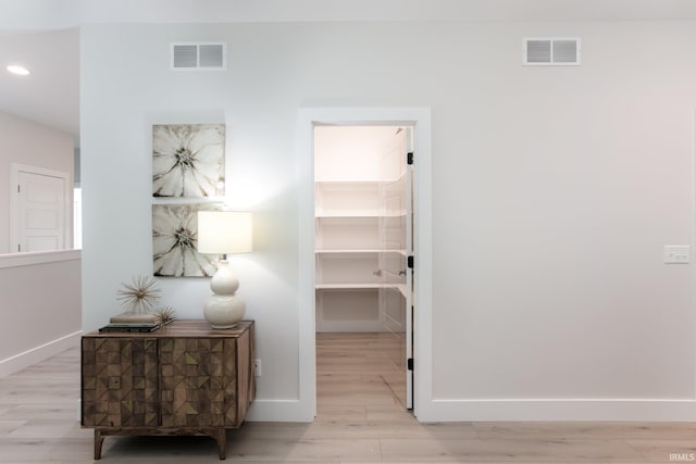 corridor featuring light hardwood / wood-style floors