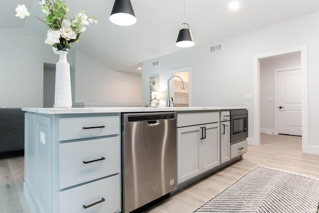 kitchen featuring dishwasher, a kitchen island with sink, pendant lighting, and light wood-type flooring