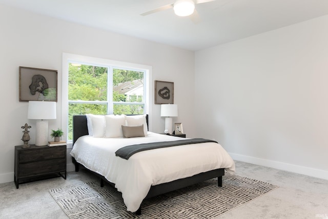 bedroom with ceiling fan and light colored carpet