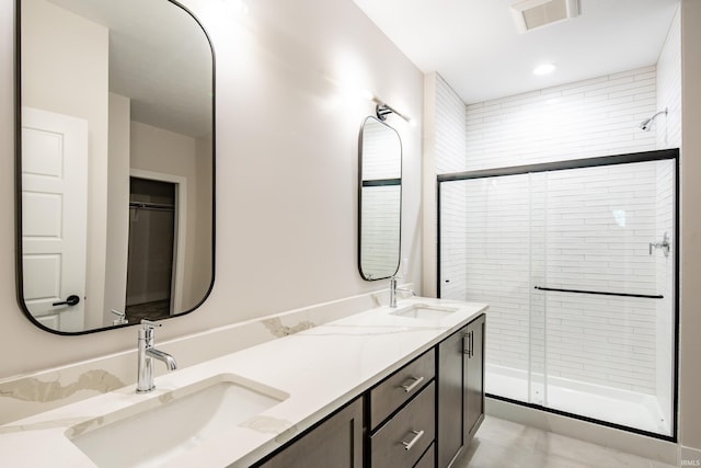 bathroom featuring vanity and a shower with door