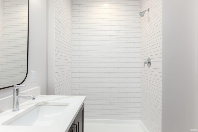 bathroom featuring vanity and a tile shower