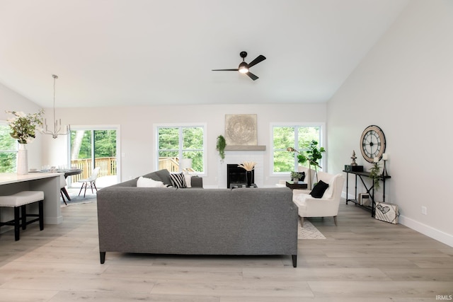 living room with light hardwood / wood-style flooring, plenty of natural light, and a brick fireplace