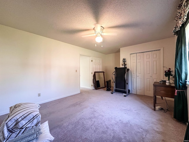 misc room featuring carpet flooring, a textured ceiling, and ceiling fan