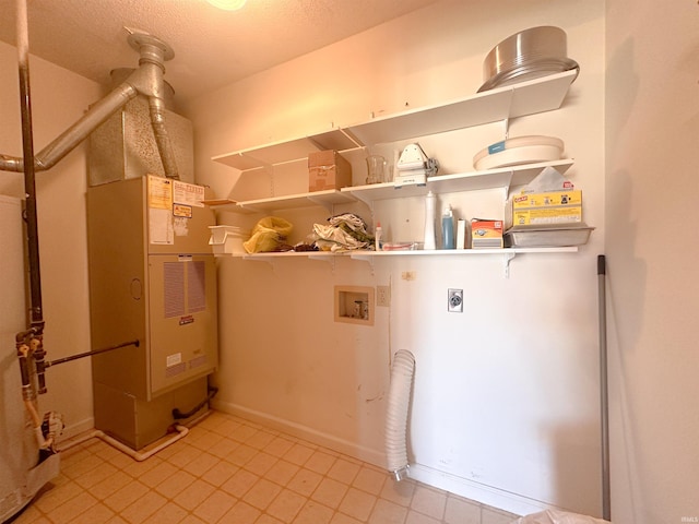 clothes washing area featuring hookup for an electric dryer, a textured ceiling, and washer hookup