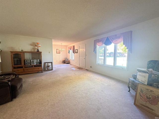 carpeted living room with a textured ceiling and a chandelier