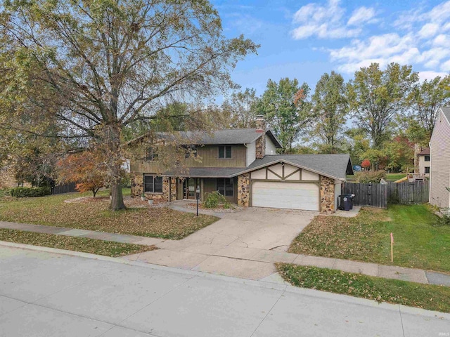 view of front of property featuring a front yard and a garage