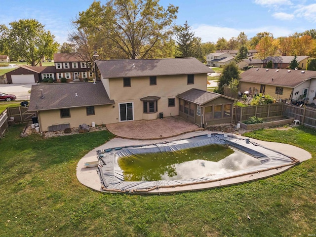 view of pool featuring a patio area, a yard, and a sunroom