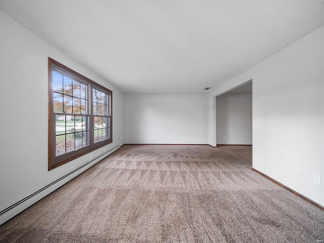 carpeted empty room with baseboard heating