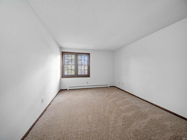 carpeted empty room with baseboard heating and a textured ceiling