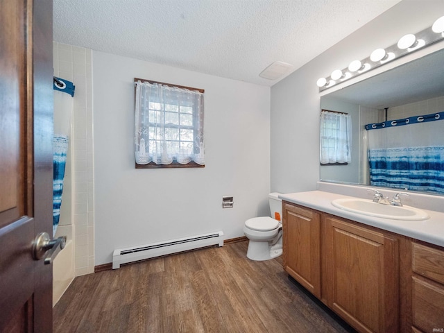 bathroom with hardwood / wood-style floors, walk in shower, toilet, vanity, and baseboard heating