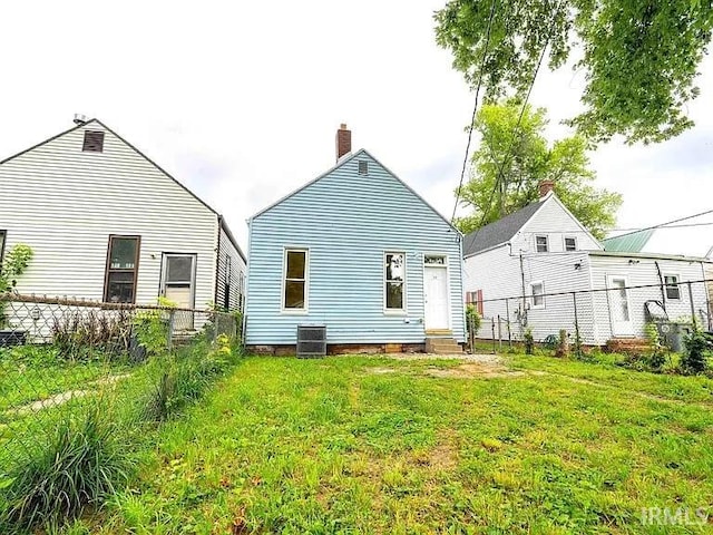 back of property with a yard and cooling unit