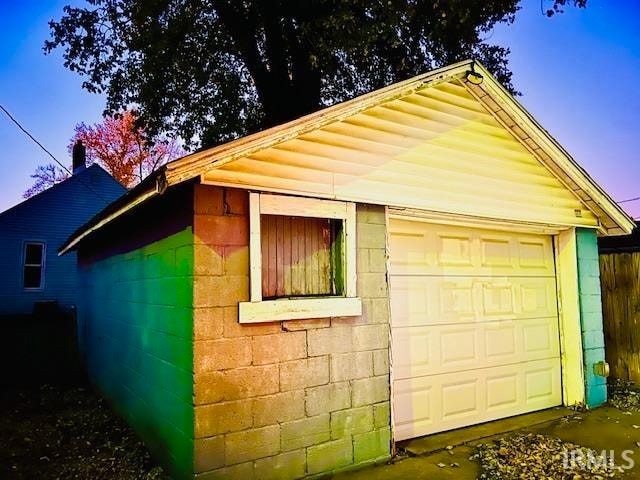 property exterior at dusk featuring a garage