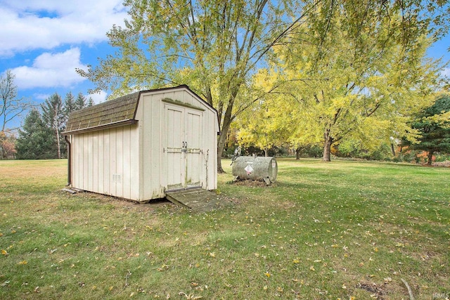 view of outbuilding featuring a lawn