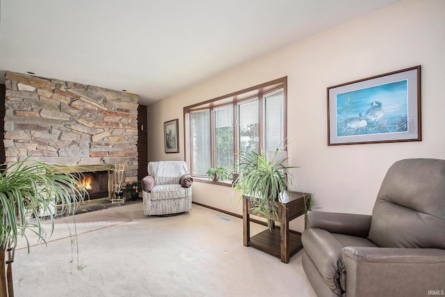 sitting room with a fireplace and carpet floors