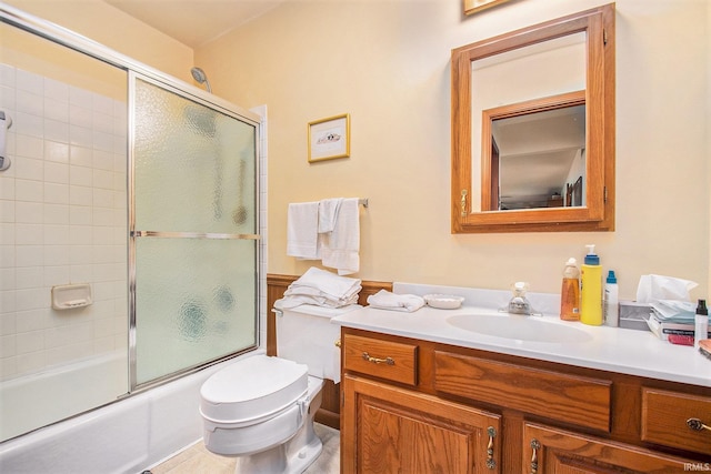 full bathroom featuring vanity, enclosed tub / shower combo, toilet, and tile patterned flooring