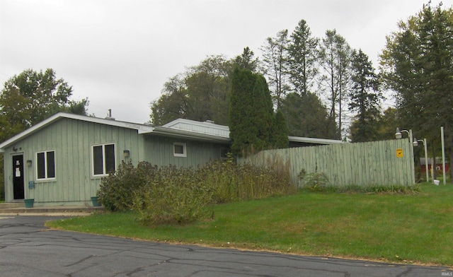 view of property exterior featuring a lawn