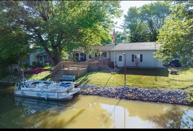 dock area featuring a deck with water view and a lawn