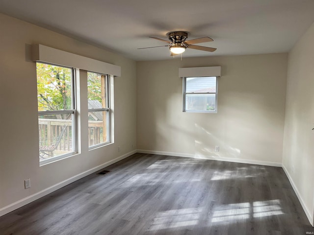 spare room featuring ceiling fan and dark hardwood / wood-style flooring