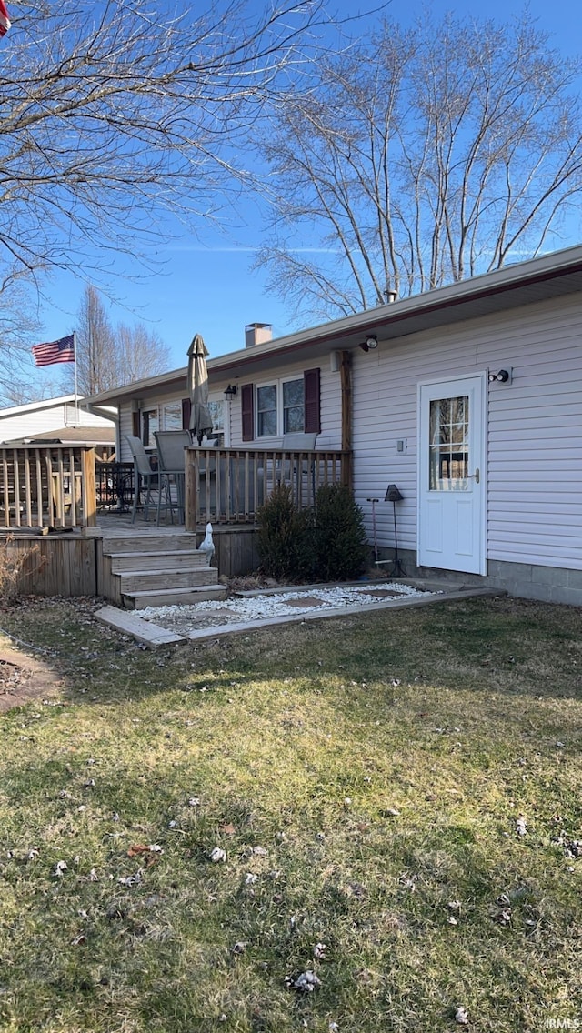 back of house featuring a yard and a deck