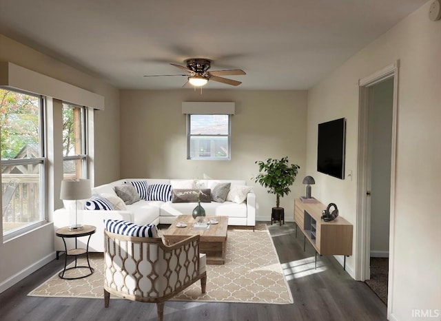 living room with dark hardwood / wood-style flooring, ceiling fan, and a wealth of natural light