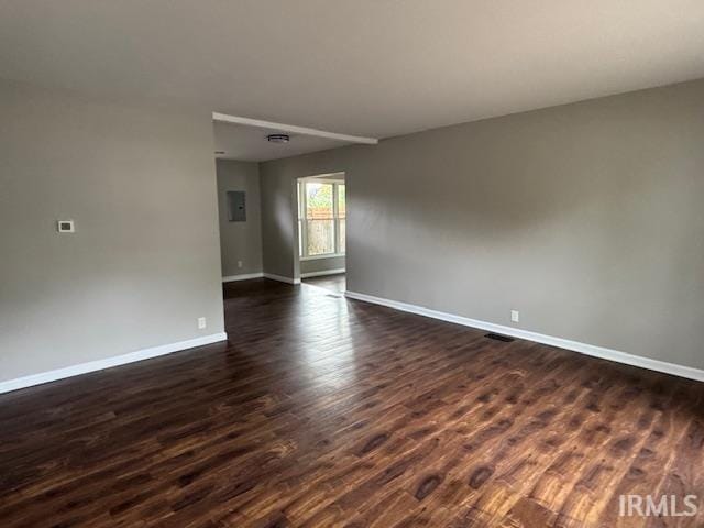 empty room featuring dark hardwood / wood-style flooring