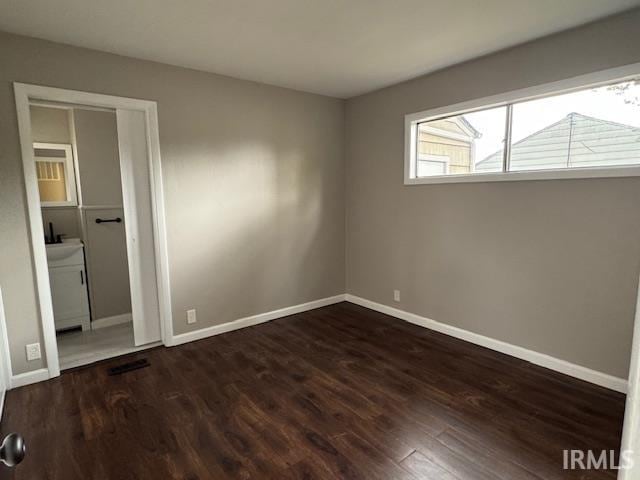 unfurnished bedroom featuring dark hardwood / wood-style floors