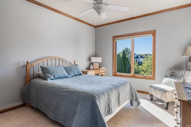 carpeted bedroom with ornamental molding and ceiling fan