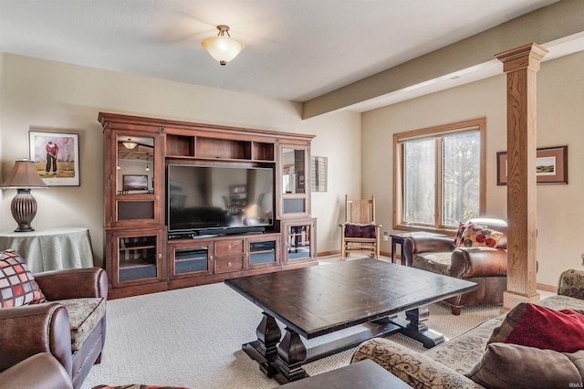 carpeted living room featuring ornate columns