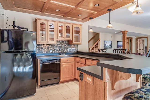 kitchen with light brown cabinetry, black appliances, coffered ceiling, decorative light fixtures, and decorative backsplash