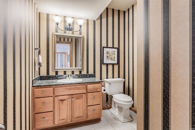 bathroom featuring toilet, a textured ceiling, vanity, and tile patterned floors