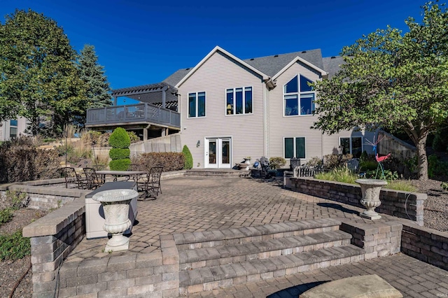 rear view of house with a patio area and french doors