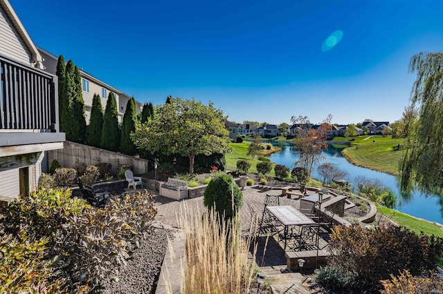 view of patio / terrace featuring a fire pit and a water view