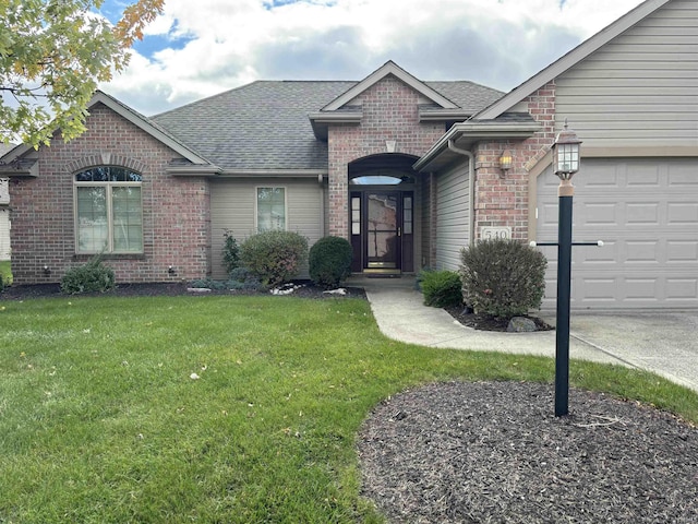 ranch-style home with a front yard and a garage