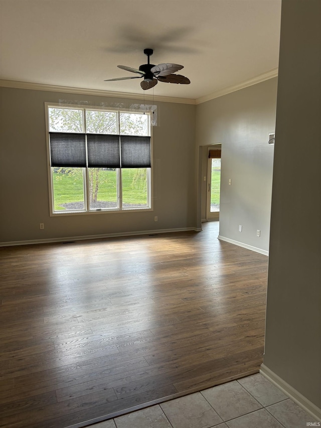 spare room with ceiling fan, a healthy amount of sunlight, and light wood-type flooring