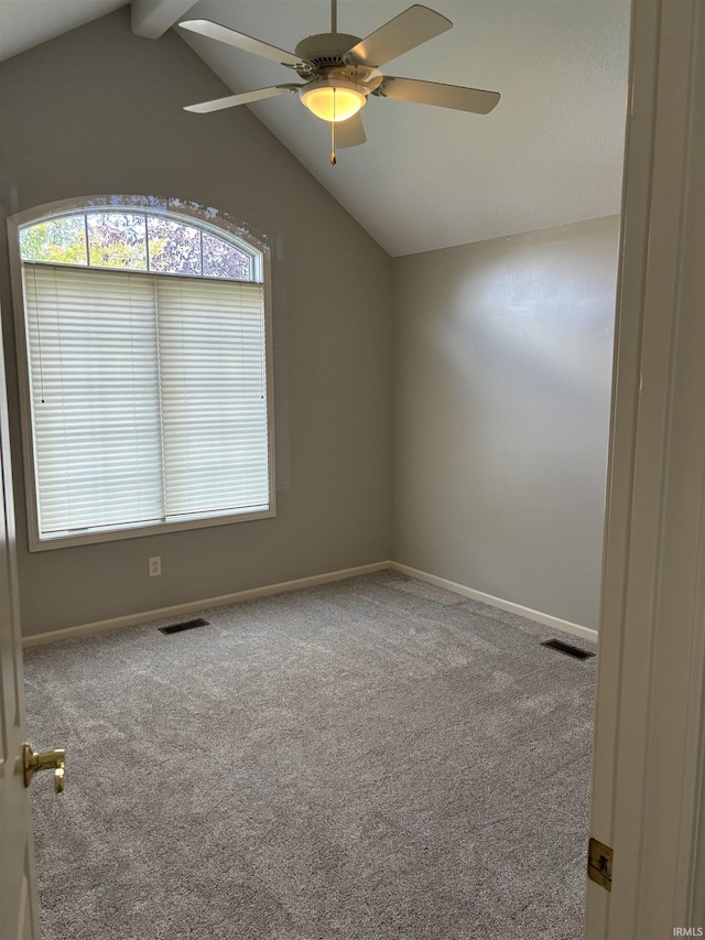 carpeted empty room with lofted ceiling with beams and ceiling fan