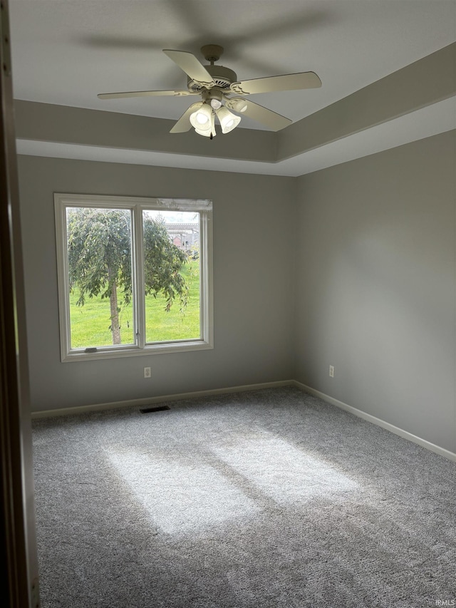 empty room with carpet flooring and ceiling fan