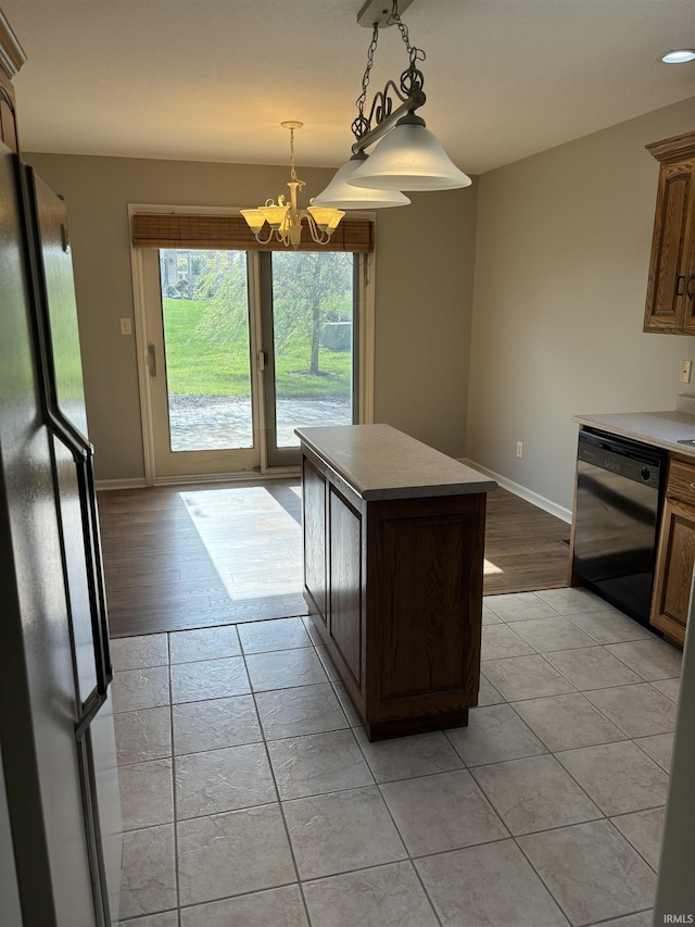 kitchen featuring dishwasher, refrigerator, light wood-type flooring, and a kitchen island