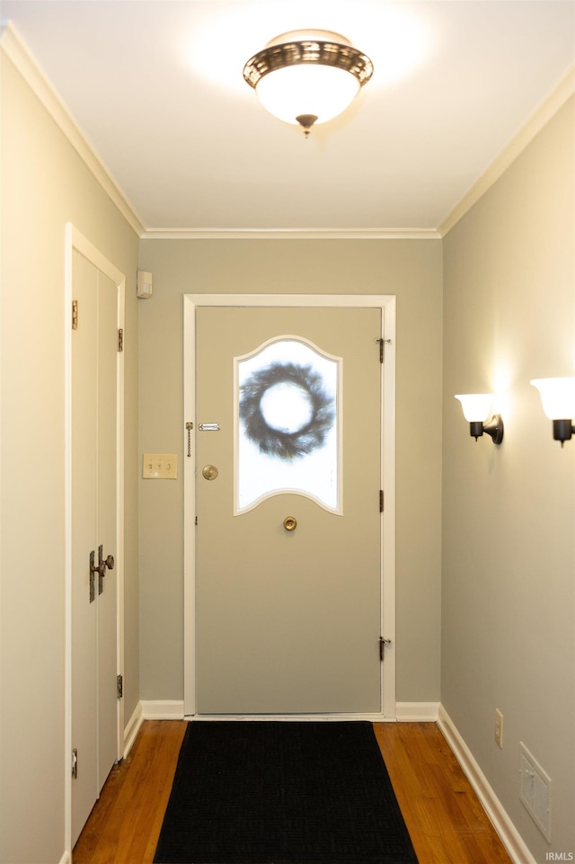 doorway to outside with crown molding and wood-type flooring