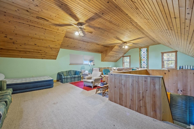 interior space featuring lofted ceiling, carpet, wood ceiling, and ceiling fan