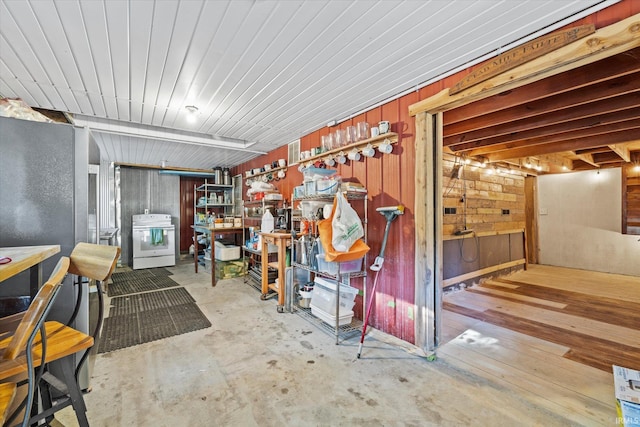 basement featuring wooden walls