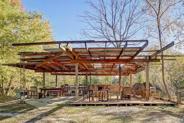 view of community featuring a wooden deck and a pergola