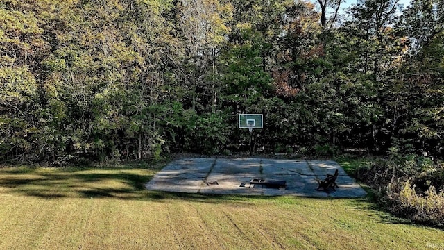 view of basketball court featuring a yard