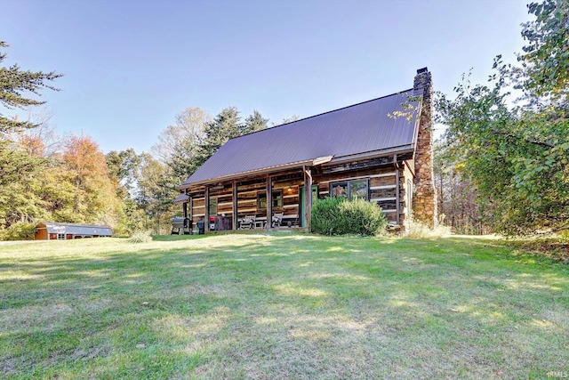 3708 State Ferry Rd, Solsberry, IN 47459 - rear view of house featuring a chimney, a lawn, an outbuilding, and metal roof