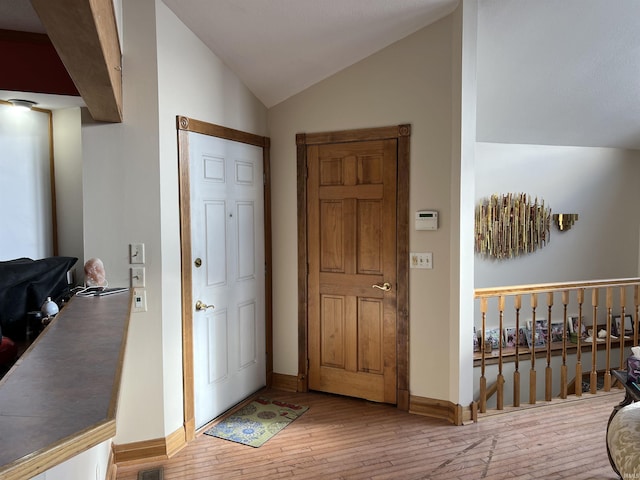 720 Ln 800 Snow Lk, Fremont, IN 46737 - foyer entrance with lofted ceiling, wood-type flooring, and baseboards