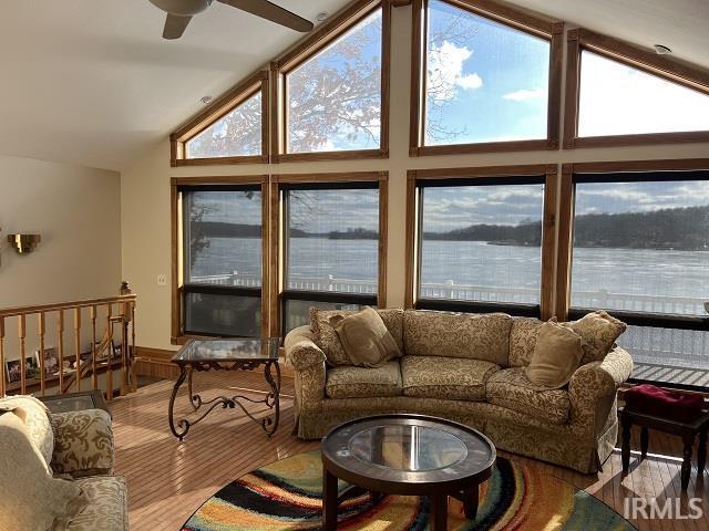 720 Ln 800 Snow Lk, Fremont, IN 46737 - living area with wood finished floors, plenty of natural light, ceiling fan, high vaulted ceiling, and a wainscoted wall