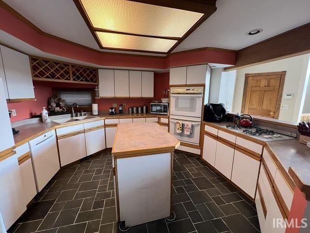 720 Ln 800 Snow Lk, Fremont, IN 46737 - kitchen featuring a sink, white appliances, white cabinets, light countertops, and a center island